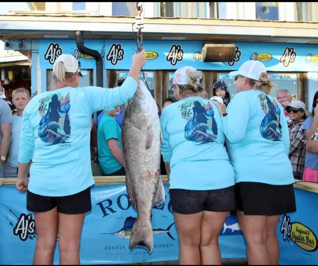 Jeannie and friends on the water in Knot His sun shirts